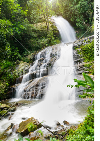Waterfall in rain forest with flare of sun light Waterfall in rain forest with flare of sun light 33956497