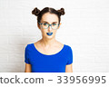 Young Girl with Blue Lips and Two Hair Buns. 33956995