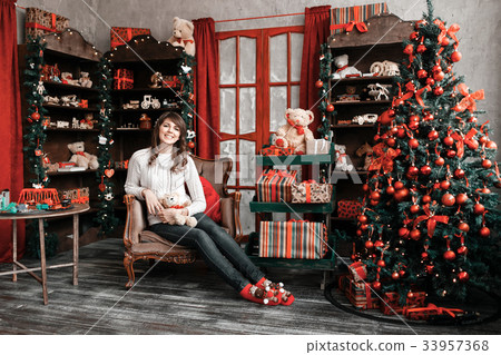 Portrait of pretty girl sits on a chair near a 33957368