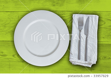 Empty plate with cutlery on light green vintage wood Empty plate with cutlery on light green vintage wood 33957829