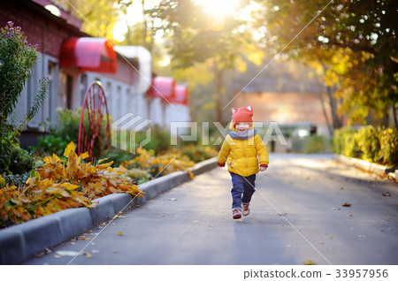Happy little child running home after kindergarten Happy little child running home after kindergarten 33957956