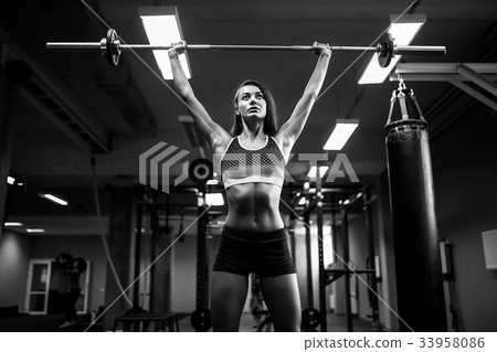 woman lifting a weight crossfit in the gym woman lifting a weight crossfit in the gym 33958086