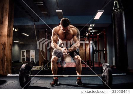 Muscular fitness man preparing to deadlift a Muscular fitness man preparing to deadlift a 33958444