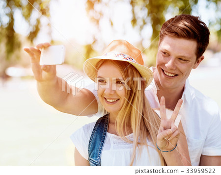 Young couple doing selfie outdoors Young couple doing selfie outdoors 33959522