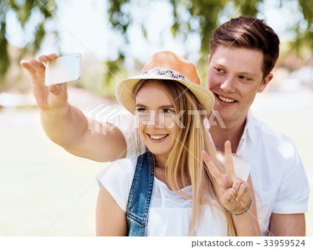 Young couple doing selfie outdoors Young couple doing selfie outdoors 33959524
