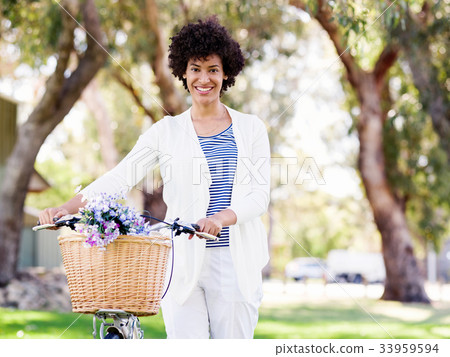 Happy young woman with bicycle Happy young woman with bicycle 33959594