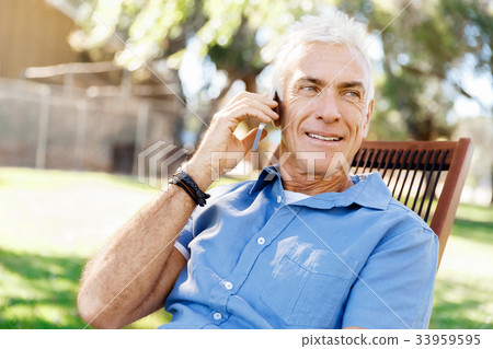 LoMature man outdoors using mobile phone LoMature man outdoors using mobile phone 33959595
