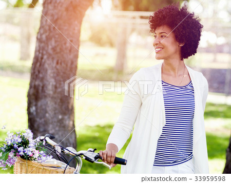 Happy young woman with bicycle Happy young woman with bicycle 33959598