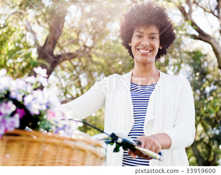 Happy young woman with bicycle 33959600