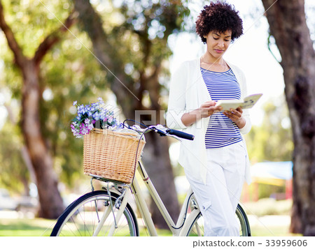 Happy young woman with bicycle Happy young woman with bicycle 33959606