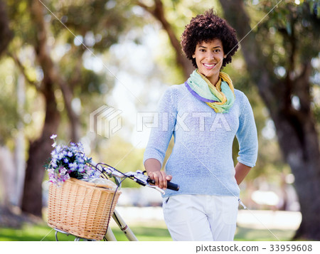 Happy young woman with bicycle Happy young woman with bicycle 33959608