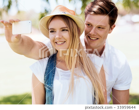 Young couple doing selfie outdoors Young couple doing selfie outdoors 33959644
