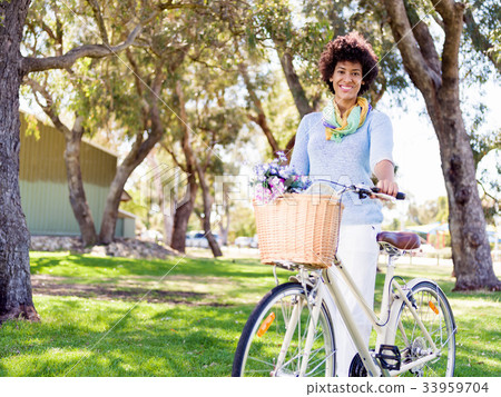 Happy young woman with bicycle Happy young woman with bicycle 33959704