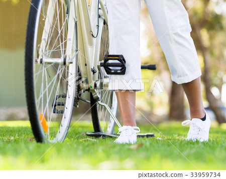 Happy young woman with bicycle Happy young woman with bicycle 33959734