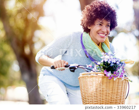 Happy young woman with bicycle 33960217
