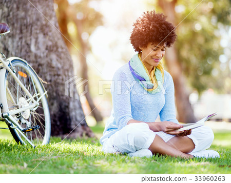 Young woman using tablet in the park. Young woman using tablet in the park. 33960263