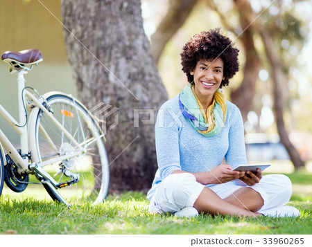 Young woman using tablet in the park. Young woman using tablet in the park. 33960265