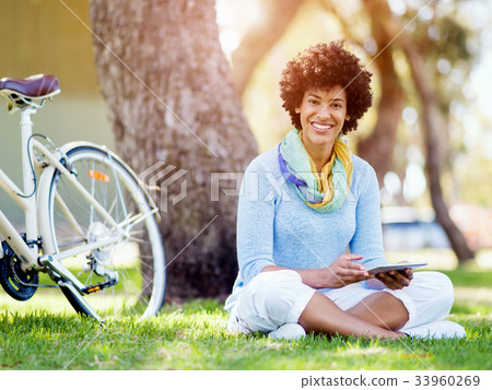 Young woman using tablet in the park. Young woman using tablet in the park. 33960269