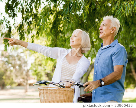 Senior couple relaxing in park Senior couple relaxing in park 33960433