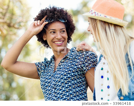 Two women friends in park Two women friends in park 33961418