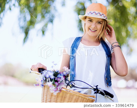 Happy young woman with bicycle 33961479
