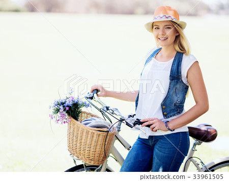 Happy young woman with bicycle Happy young woman with bicycle 33961505
