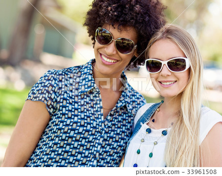 Two women friends in park Two women friends in park 33961508