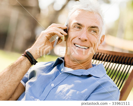 LoMature man outdoors using mobile phone LoMature man outdoors using mobile phone 33961511