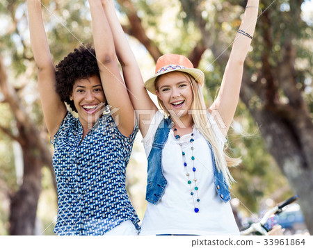 Two women friends in park Two women friends in park 33961864
