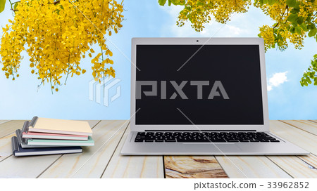 Notebook with laptop on wood table 33962852