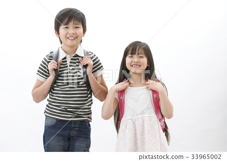 Brother and sister carrying a school bag Brother and sister carrying a school bag 33965002