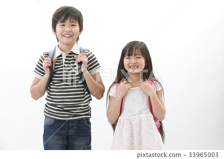 Brother and sister carrying a school bag Brother and sister carrying a school bag 33965003