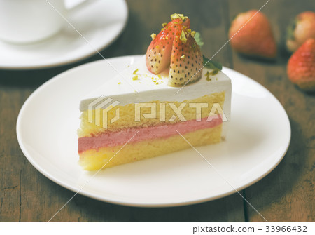 close up of strawberry cream cake on white 33966432