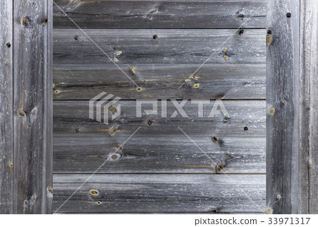 Frame of a seasoned old gray wooden fence closeup Frame of a seasoned old gray wooden fence closeup 33971317