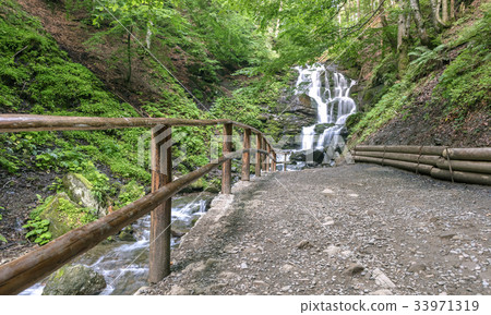 A path to the great waterfall of a mountain river. A path to the great waterfall of a mountain river. 33971319