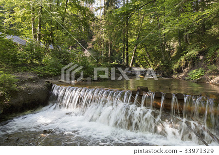 Cascading waterfall of a stream in the Carpathians Cascading waterfall of a stream in the Carpathians 33971329
