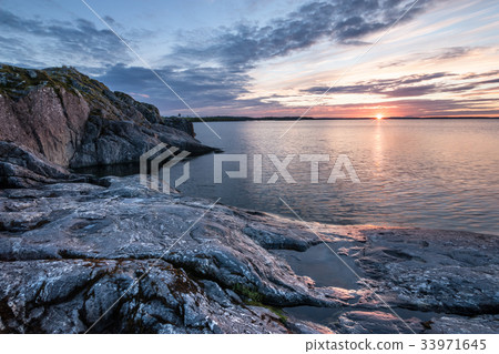 Sunrise over lake with stony coast Sunrise over lake with stony coast 33971645