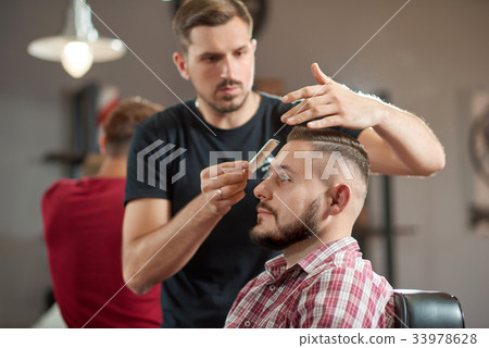 Young man at the barbershop 33978628