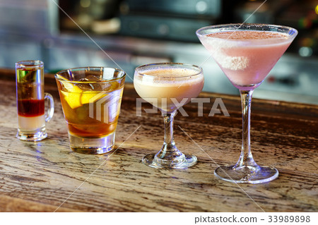 a variety of cocktails in a nightclub 33989898