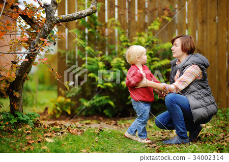 Beautiful women and her grandson in garden 34002314