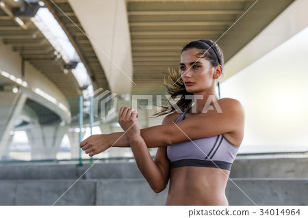 Young caucasian woman exercising outdoors Young caucasian woman exercising outdoors 34014964