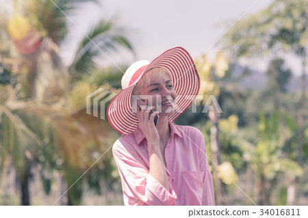 Happy Smiling Woman In Pink Hat Talking Phone Call Happy Smiling Woman In Pink Hat Talking Phone Call 34016811