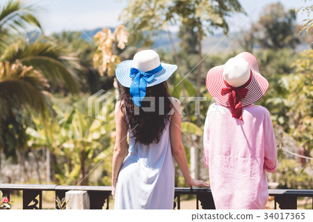 Back Rear View Of Young Women Couple Wearing Hats Back Rear View Of Young Women Couple Wearing Hats 34017365
