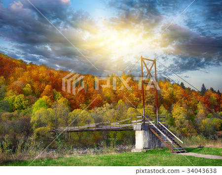 Wooden bridge over mountain river 34043638