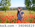 Romantic woman in sundress on poppy field 34046819
