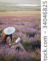 Romantic woman with book on lavender field 34046825