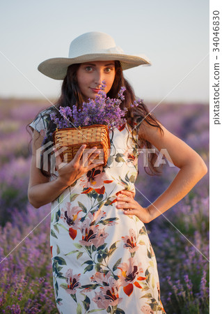 Woman with bunch of lavender in wicker basket Woman with bunch of lavender in wicker basket 34046830