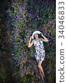 Romantic slender woman lies on lavender field 34046833
