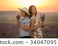 Two women with lavender bunches on the sunset 34047095