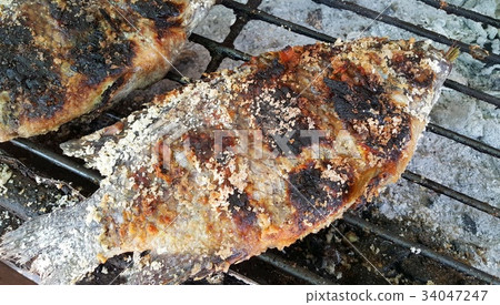 Scorched-skin salt-crusted grilled Tilapia fish 34047247